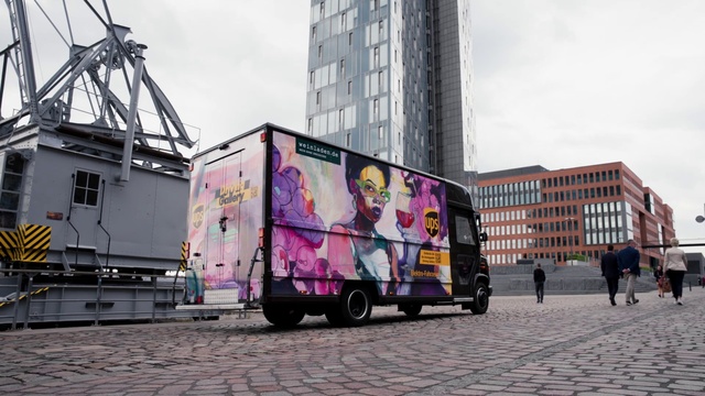 Video Reference: Building, Vehicle, Sky, Wheel, Tire, Window, Mode of transport, Art, Skyscraper, Asphalt