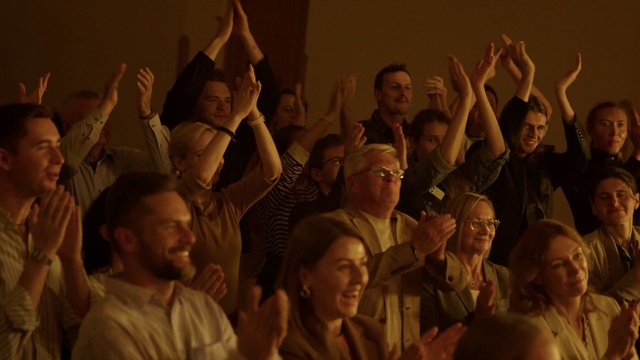 Video Reference: Head, Smile, Gesture, Crowd, Entertainment, Social group, Hat, Fun, Event, Team