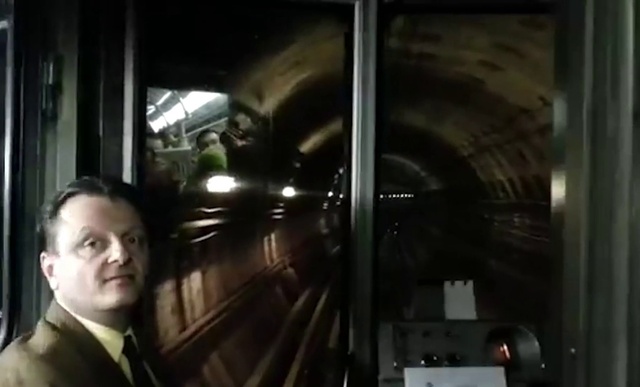 Video Reference: Fixture, Collar, Machine, Public transport, Darkness, Glass, Formal wear, Tie, Transport, Metal