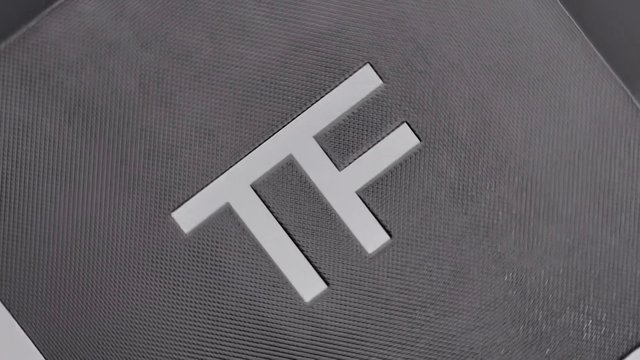 Video Reference: logo, monogram, abstract, geometric, close-up, textured, gray, surface, pattern, minimal, branding, design, metallic, modern