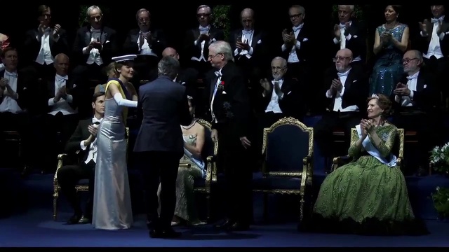 Video Reference: Hat, Entertainment, Music, Chair, Musician, Performing arts, Suit, Gown, Formal wear, Musical instrument