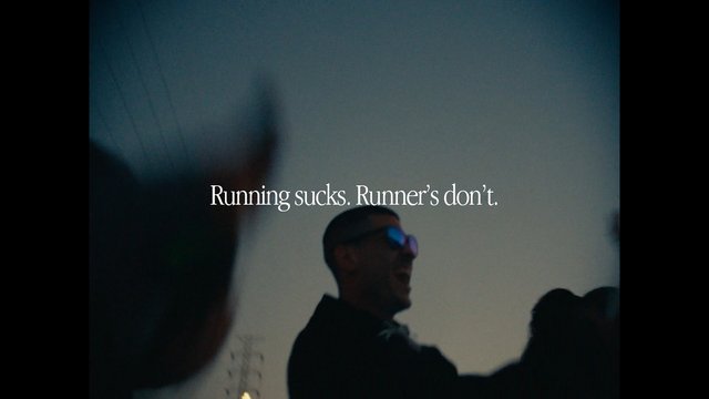 Video Reference: running, runner, text overlay, low light, blurred, person, sunglasses, outdoor, crowd, motivational, sports, night, silhouette, advertisement