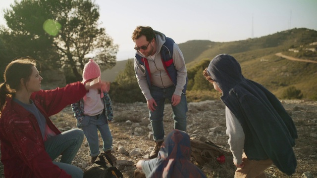 Video Reference: Sky, Plant, Hat, Outdoor recreation, People in nature, Luggage and bags, Tree, Grass, Leisure, Landscape