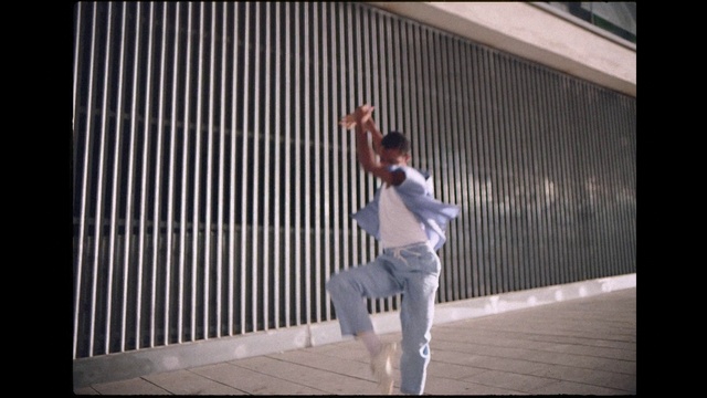 Video Reference: Trousers, Flash photography, Wall, Event, Performing arts, Entertainment, Font, Performance art, Performance, Audio equipment