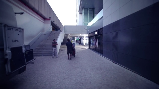 Video Reference: Building, Sky, Road surface, Asphalt, City, Flooring, Facade, Road, Electric blue, Pedestrian