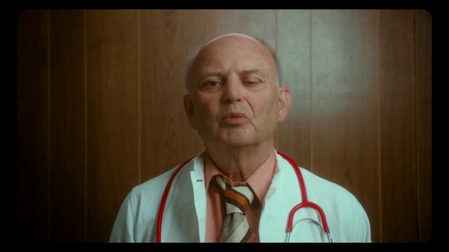 Video Reference: Face, Human body, Jaw, Neck, Wood, Wrinkle, Facial hair, Event, Throat, Dress shirt