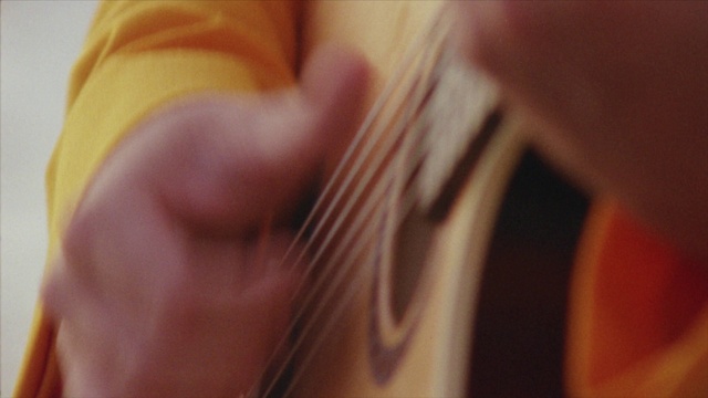 Video Reference: Musical instrument, String instrument, String instrument, Guitar accessory, Human body, Dress, String instrument accessory, Guitar, Gesture, Finger