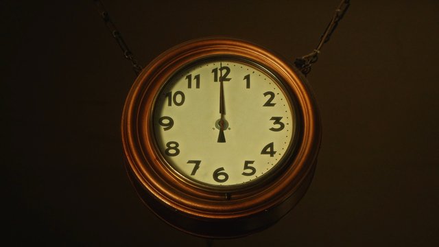 Video Reference: clock, wall clock, vintage, hanging, time, analog, copper, close-up, interior, dark background, antique, round