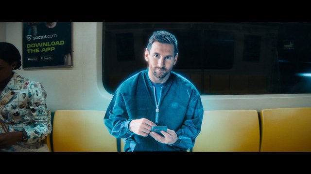Video Reference: man, smartphone, train, subway, public transit, bench, commuter, interior, passenger, advertisement, indoors, seated, travel, urban, portrait
