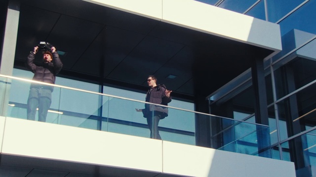 Video Reference: Azure, Suit, Facade, Glass, Technology, Stage equipment, Composite material, Electric blue, Commercial building, Display device