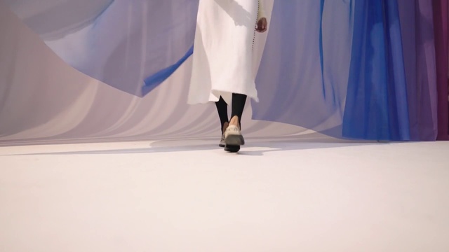 Video Reference: Sleeve, Fashion design, Flooring, Human leg, Electric blue, Sportswear, Knee, Event, Performing arts, Art