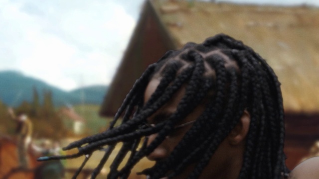 Video Reference: Cornrows, Sky, Dreadlocks, Braid, Audio equipment, Wood, Tree, Event, Automotive tire, Metal