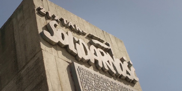 Video Reference: Sky, Font, Building, Wood, Facade, Monument, City, Signage, Art, Composite material