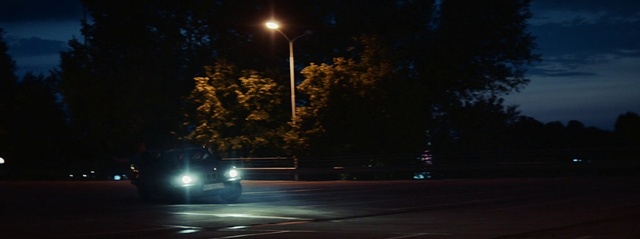 Video Reference: Automotive lighting, Street light, Road surface, Asphalt, Headlamp, Woody plant, Tree, Midnight, Tints and shades, Plant