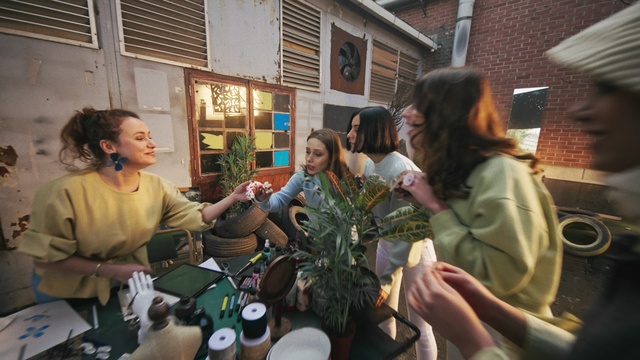 Video Reference: Hairstyle, Chair, Fun, Event, Leisure, Conversation, Houseplant, Room, Crowd, Sitting