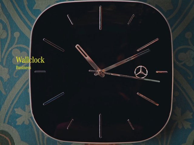 Video Reference: wall clock, clock face, home decor, interior, close-up, black clock, metal hands, analog clock, wall mounted, patterned wall, text overlay, decorative