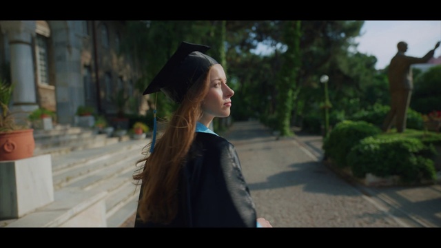 Video Reference: Plant, Hat, Headgear, Academic dress, Mortarboard, Eyewear, Grass, Formal wear, Travel, Graduation