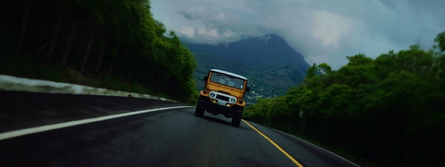 Video Reference: Sky, Cloud, Vehicle, Tire, Automotive lighting, Automotive tire, Mountain, Road surface, Asphalt, Motor vehicle