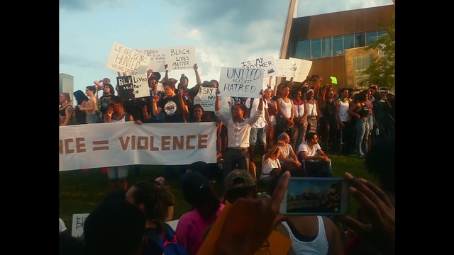 Video Reference: Sky, Orange, Cloud, Crowd, T-shirt, Event, Font, Tree, Team, Public event