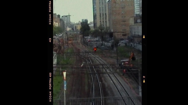 Video Reference: Building, Window, Sky, Electricity, Tree, Thoroughfare, Track, Railway, Vehicle, Road