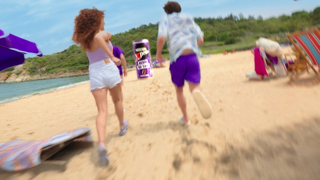 Video Reference: Sky, Shorts, Cloud, Leg, People on beach, Plant, Beach, Trunks, Gesture, Body of water