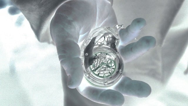 Video Reference: gloved hands, close-up, watch, mechanical device, transparent, circular object, hands, inspection, equipment, bright background, macro, technology