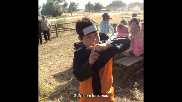 Video Reference: child, costume, outdoors, gesture, group, bench, field, sunlight, performance, event, children, summer, rural, portrait, subtitles