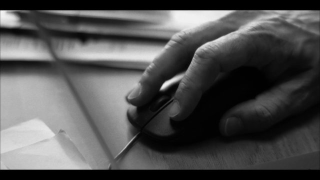 Video Reference: hand, mouse, computer, desk, papers, close-up, black and white, office, work, technology, cursor, input device