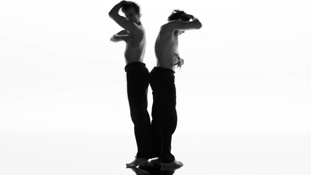 Video Reference: dancers, dance, silhouette, black and white, studio, pose, back to back, shirtless, movement, performance, minimalist, white background, artistic, men, full body