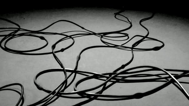 Video Reference: cables, wires, tangled, abstract, monochrome, close-up, floor, chaos, messy, loops, texture, minimal