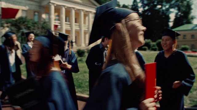 Video Reference: Fashion, Gesture, Hat, Crowd, Mortarboard, Academic dress, Fun, Event, Smile, Formal wear