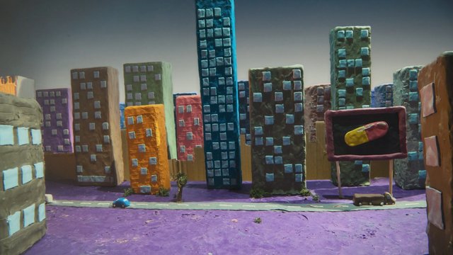 Video Reference: clay model, miniature city, city skyline, buildings, handmade, art project, stop motion, model town, billboard, road, toy car, colorful, craft, urban scene