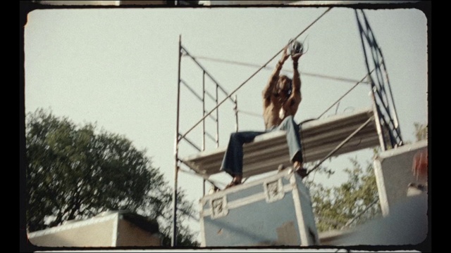Video Reference: Sky, Electricity, Event, Entertainment, Pole, Recreation, Font, Electrical supply, Elbow, Tree