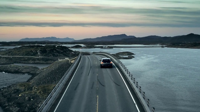 Video Reference: Sky, Cloud, Water, Mountain, Car, Vehicle, Tire, Asphalt, Road surface, Highland
