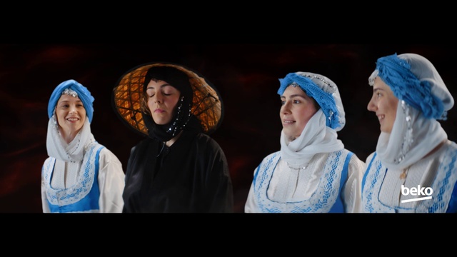 Video Reference: Face, Outerwear, Blue, Human body, Entertainment, Wrap, Performing arts, Headgear, Fun, Event