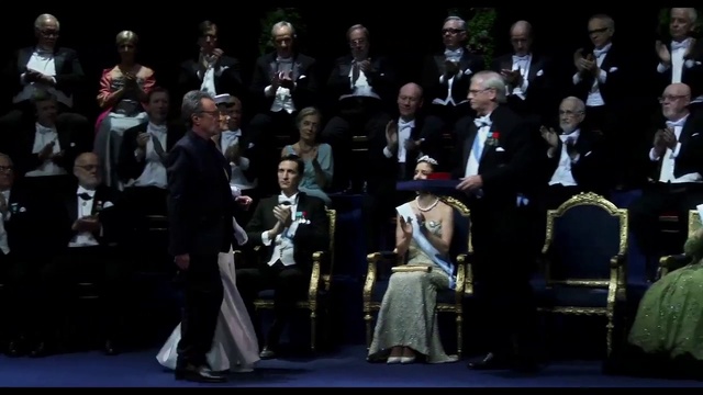 Video Reference: Suit trousers, Entertainment, Chair, Music, Formal wear, Suit, Event, Tie, Uniform, Performing arts