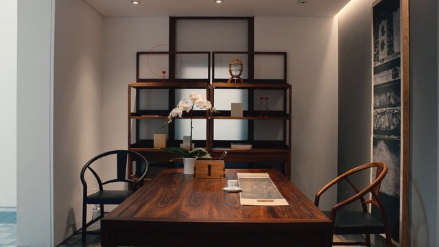 Video Reference: interior, modern, room, wooden table, chairs, shelving, orchid, decor, minimalist, office, showroom, furniture, indoor, design