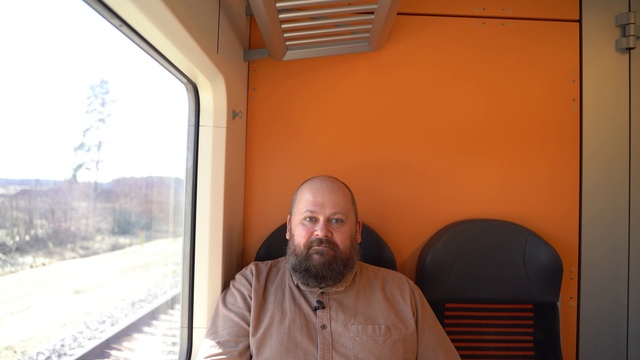Video Reference: Beard, Plant, Train, Wood, Comfort, Facial hair, Sky, Rolling stock, Railway, Fun