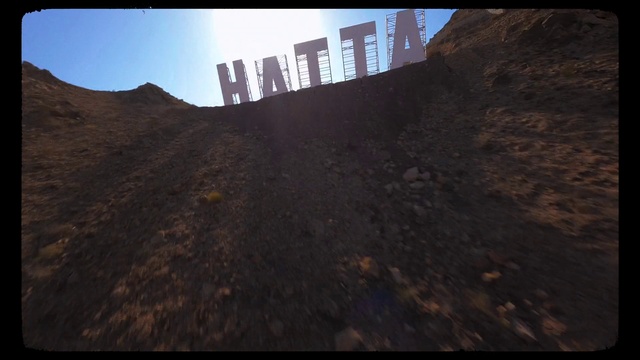 Video Reference: Sky, Slope, Terrain, Asphalt, Tints and shades, Mountain, Font, Landscape, Soil, Rectangle