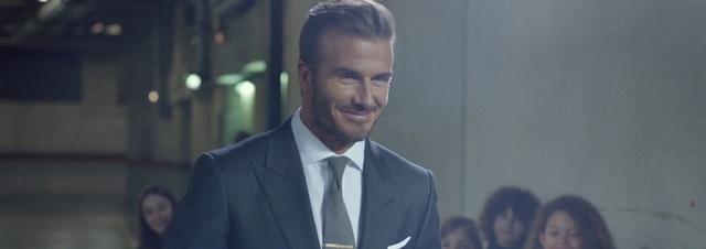 Video Reference: Forehead, Smile, Eyebrow, Coat, Dress shirt, Sleeve, Flash photography, Gesture, Suit, Collar