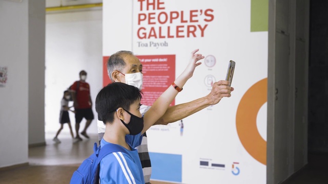 Video Reference: Gesture, Font, T-shirt, Event, Job, Mobile phone, Shorts, Brand, Advertising, Room