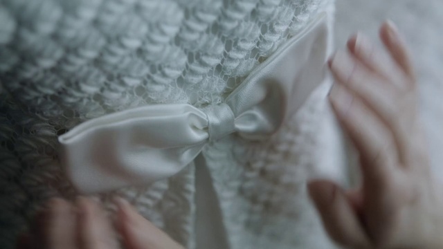 Video Reference: Hand, Dress, Finger, Gesture, Bridal clothing, Wedding dress, Embellishment, Nail, Wood, Bridal accessory