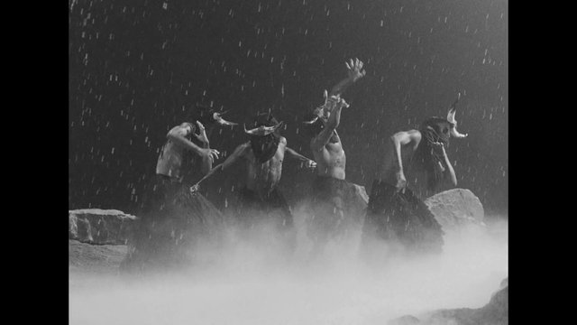 Video Reference: black and white, performers, dancers, masked, horned masks, rain, mist, rocks, theatrical, ritual, stage performance, dramatic lighting, abstract, motion, costume