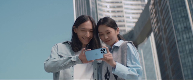 Video Reference: Outerwear, Smile, Mobile phone, Sleeve, Building, Communication Device, Gesture, Interaction, Happy, Gadget