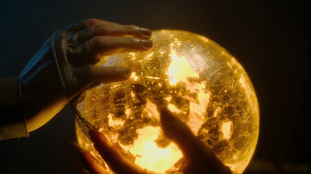 Video Reference: Hand, Amber, Helmet, Automotive lighting, Heat, Art, Astronomical object, Glass, Metal, Close-up