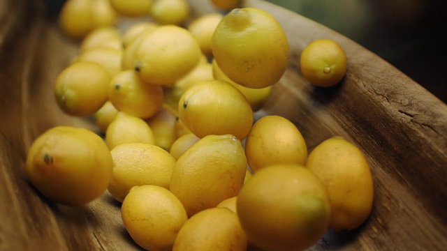 Video Reference: citrus, fruit, yellow fruit, lemons, produce, fresh, wooden bowl, close-up, food, natural, organic, harvest, still life