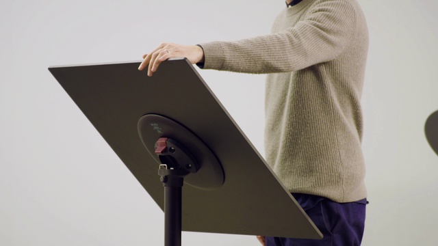 Video Reference: Outerwear, Sleeve, Output device, Dress shirt, Gadget, Gesture, Audio equipment, Elbow, Blazer, Eyewear