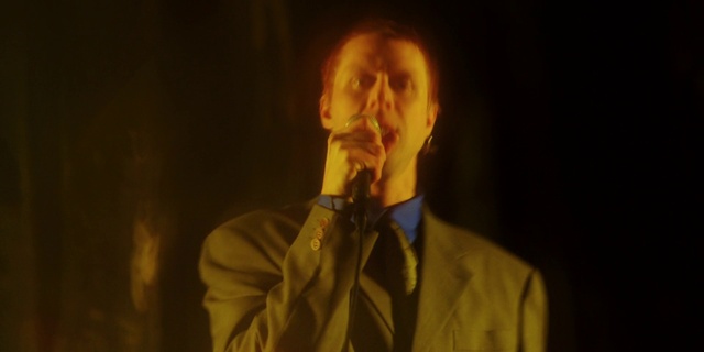 Video Reference: Microphone, Musician, Gesture, Tie, Performing arts, Dress shirt, Music, Music artist, Entertainment, Collar