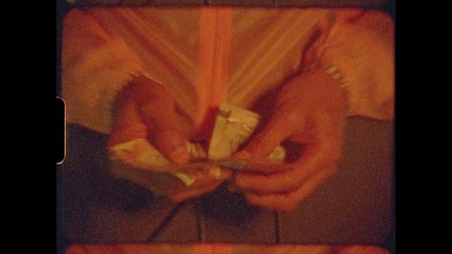 Video Reference: hands, paper, close-up, craft, manual work, folding, tool, warm light, film grain, abstract, indoor, texture, action, low light