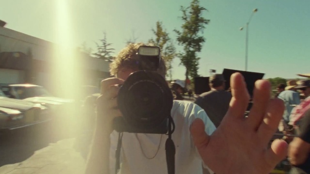 Video Reference: Hand, Sky, Photographer, Eyewear, Camera, Gesture, Camera lens, Cameras & optics, Tree, Cool
